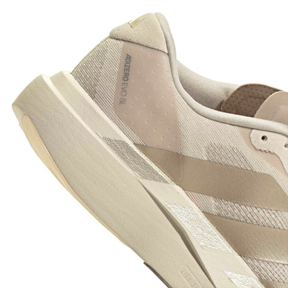 Beige Adidas running shoe on a white background