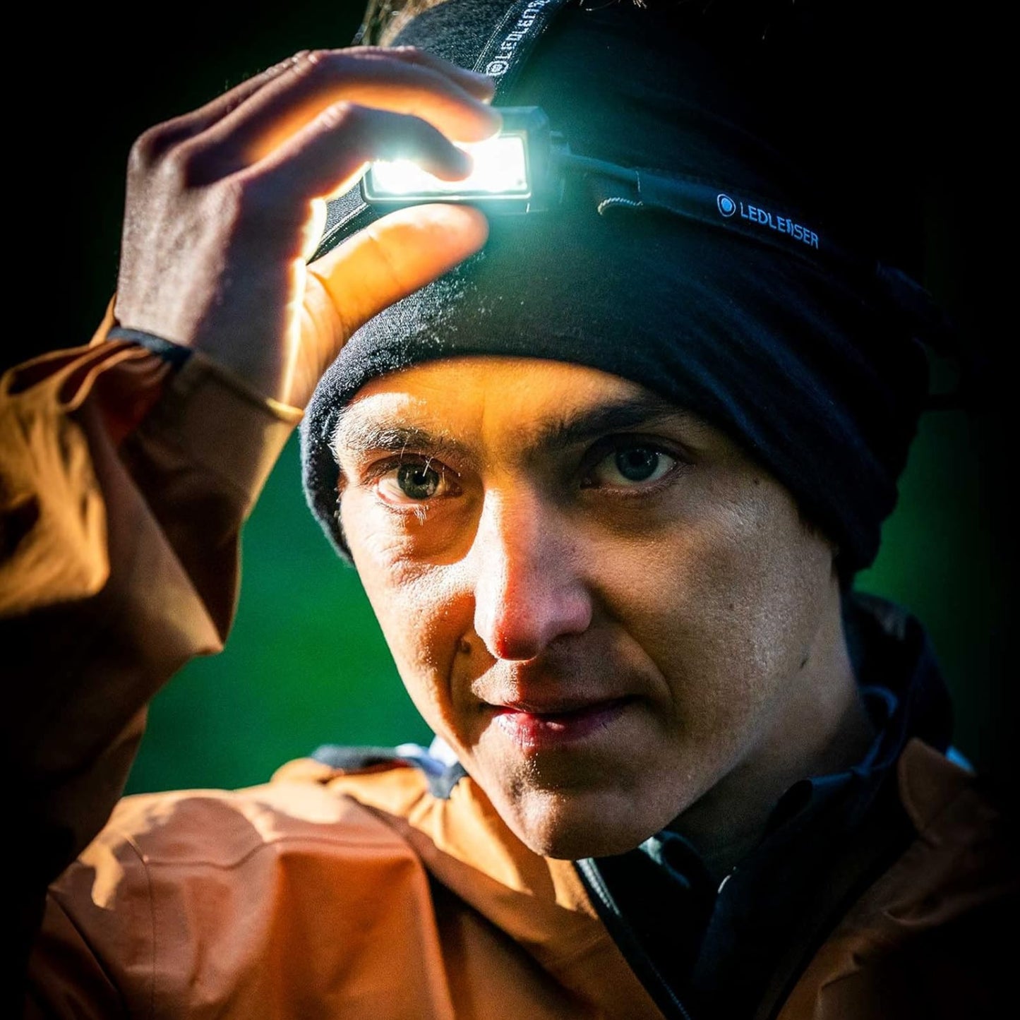 Person wearing a headlamp in a dark setting
