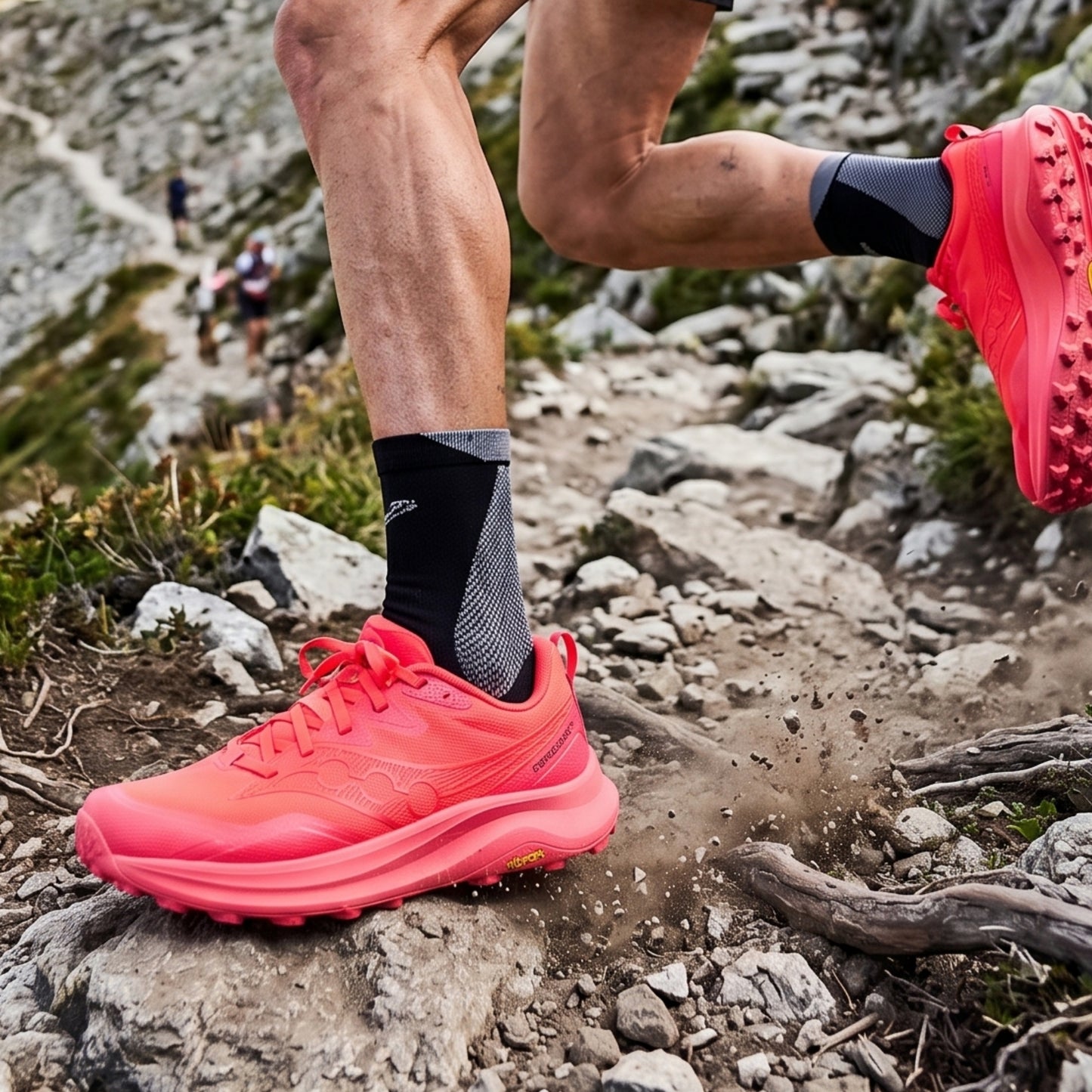 Person running on a rocky trail wearing bright red running shoes.