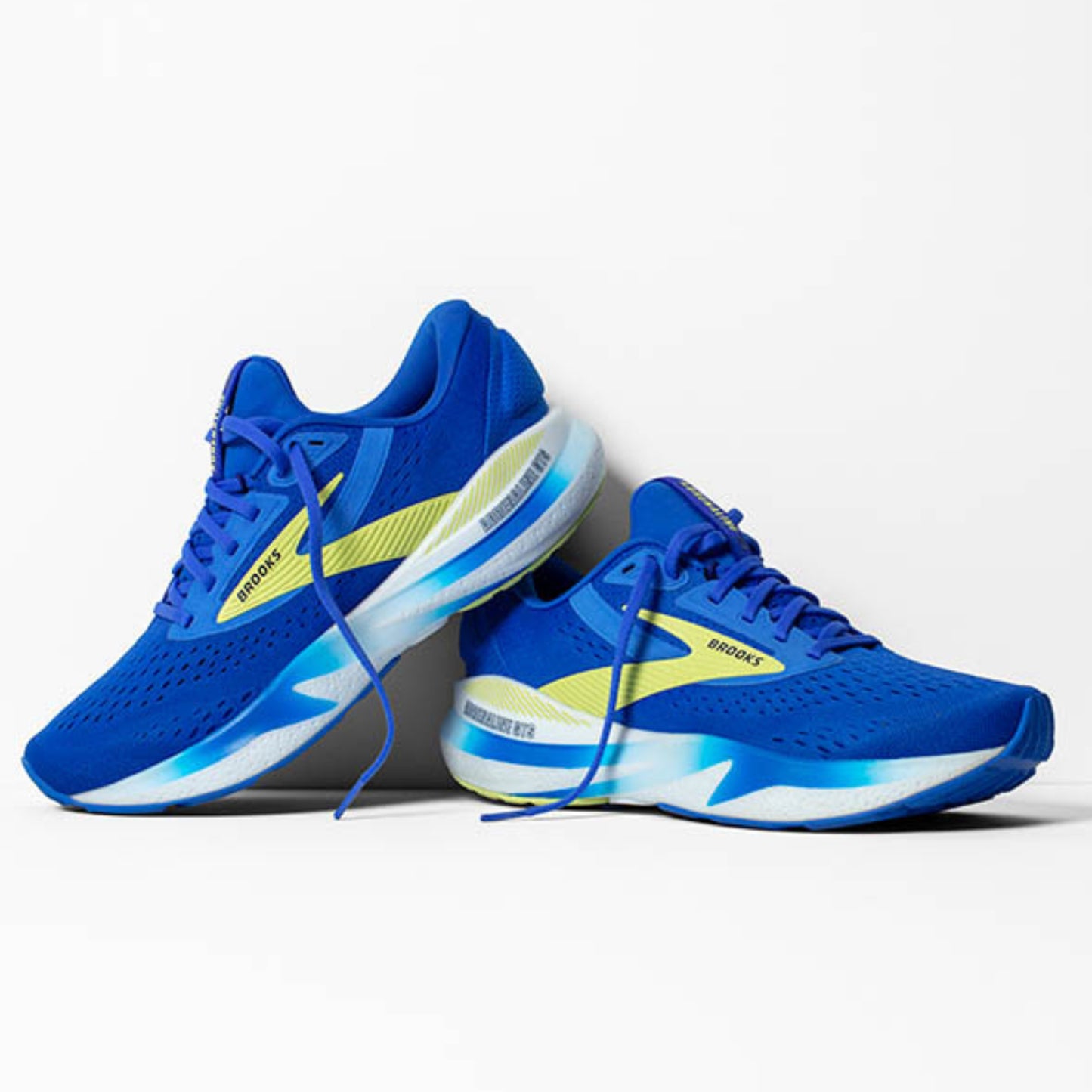 Blue Brooks running shoes with yellow accents on a white background