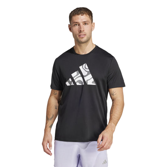 Man wearing a black Adidas t-shirt with a logo on a white background
