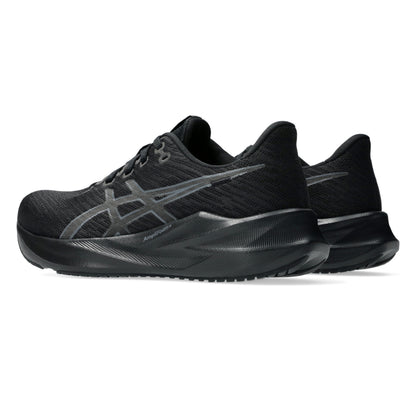 Black Asics running shoes with a prominent brand logo on a white background