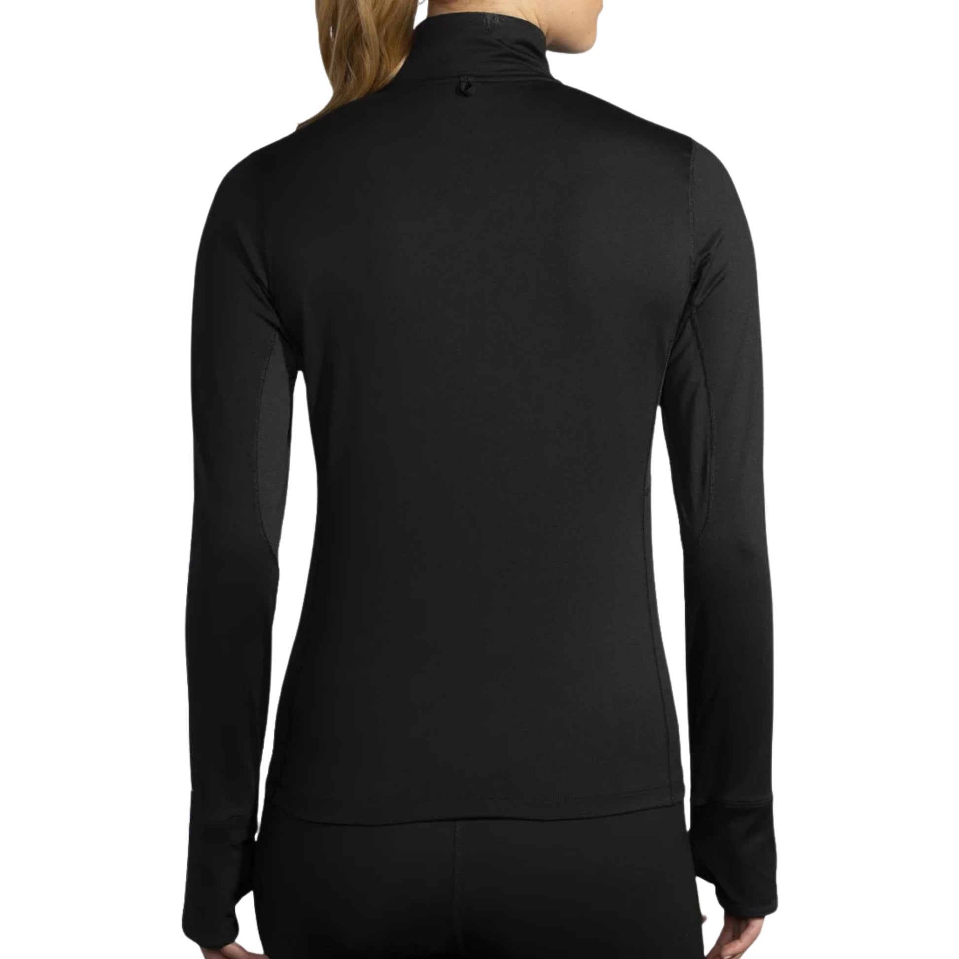 Woman wearing a black long sleeve Brooks shirt on a white background