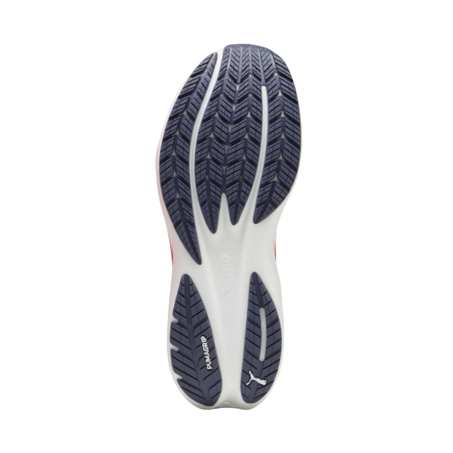 The outsole of a Puma running shoe, showing a white midsole with dark navy blue grip tread and a small white Puma logo near the heel.