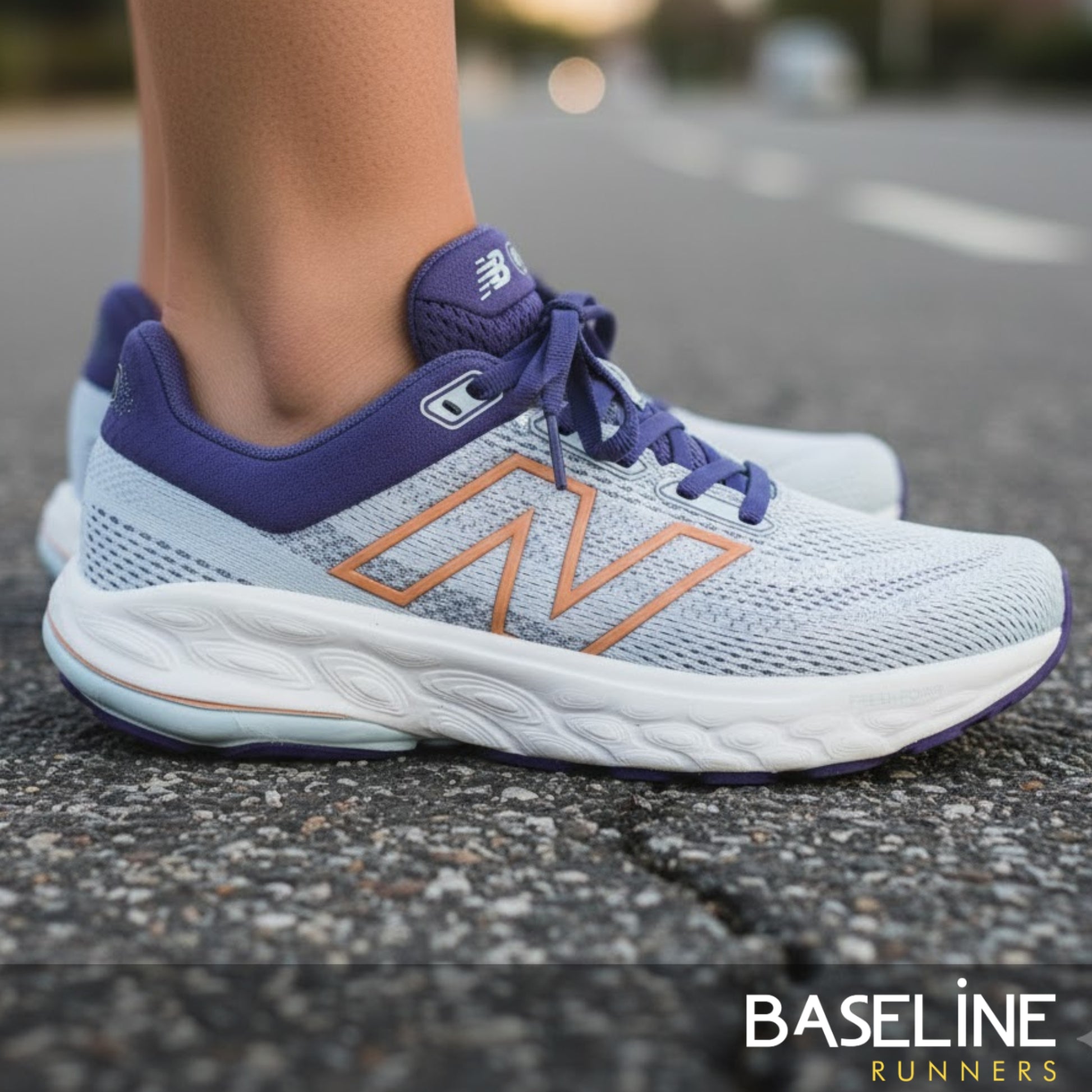 Light blue and purple running shoes on a road with 'Baseline Runners' branding.