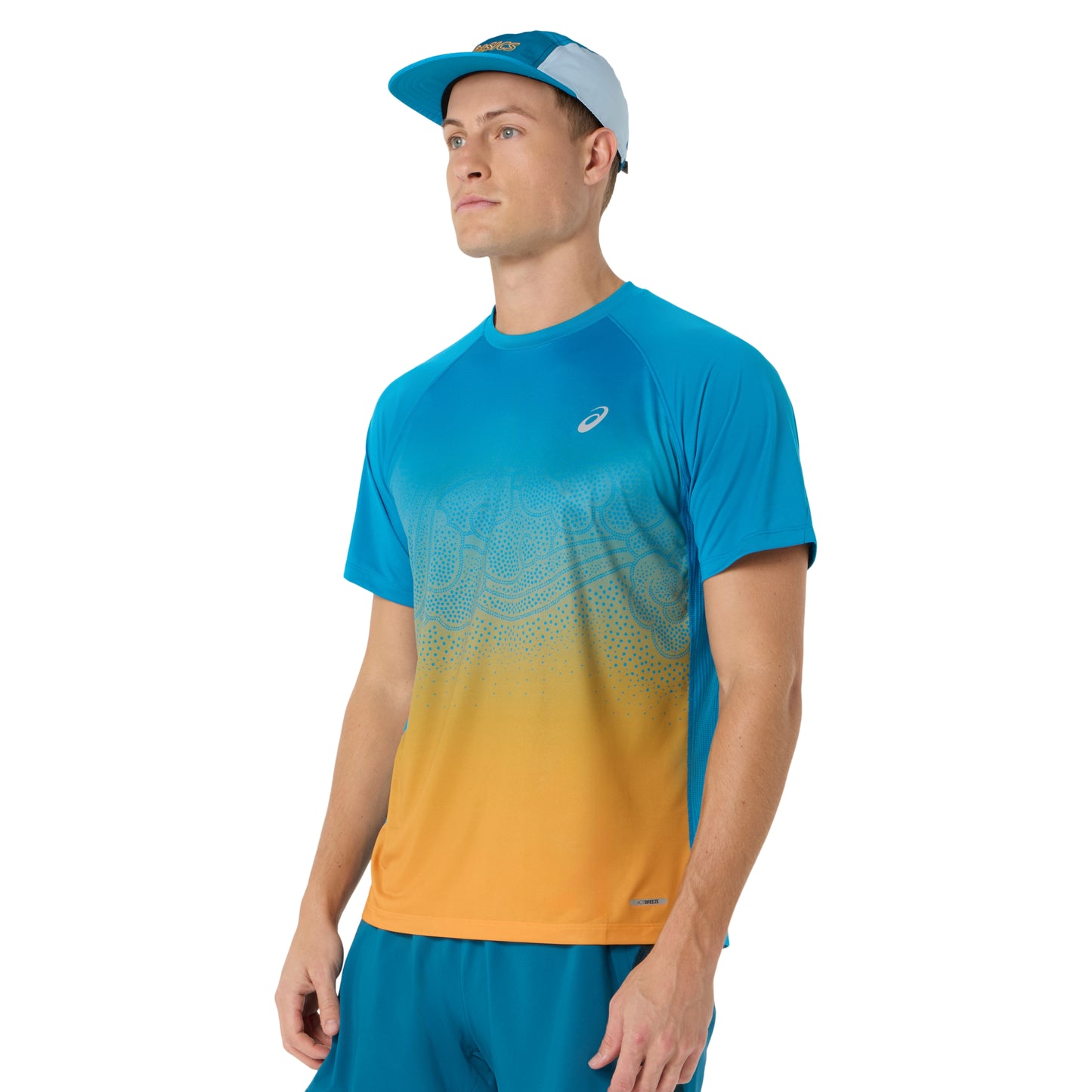 Person wearing blue and yellow Asics running shirt on a white background