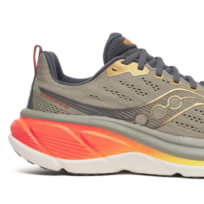 Gray Saucony running shoe with orange sole on a white background