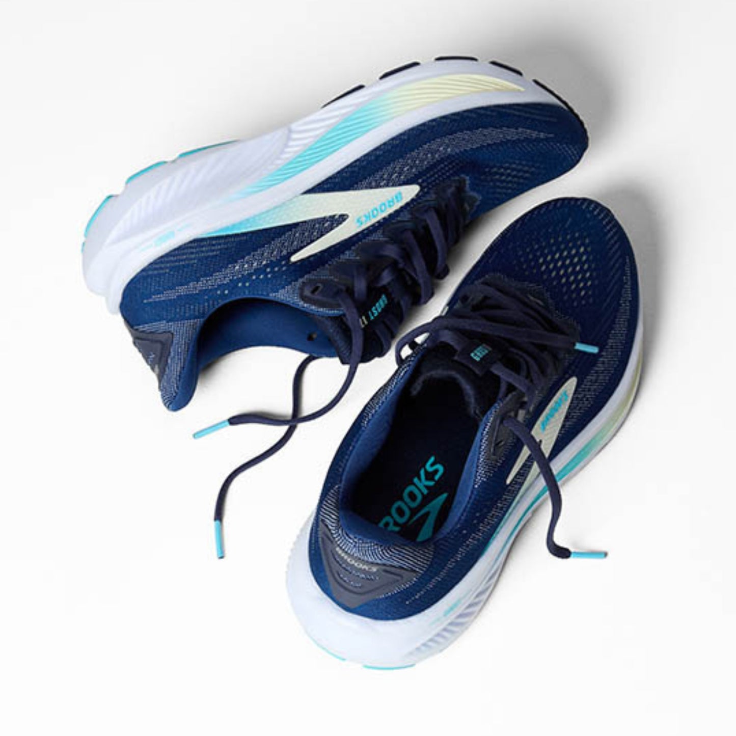 Pair of Brooks blue running shoes with white soles on a light gray background