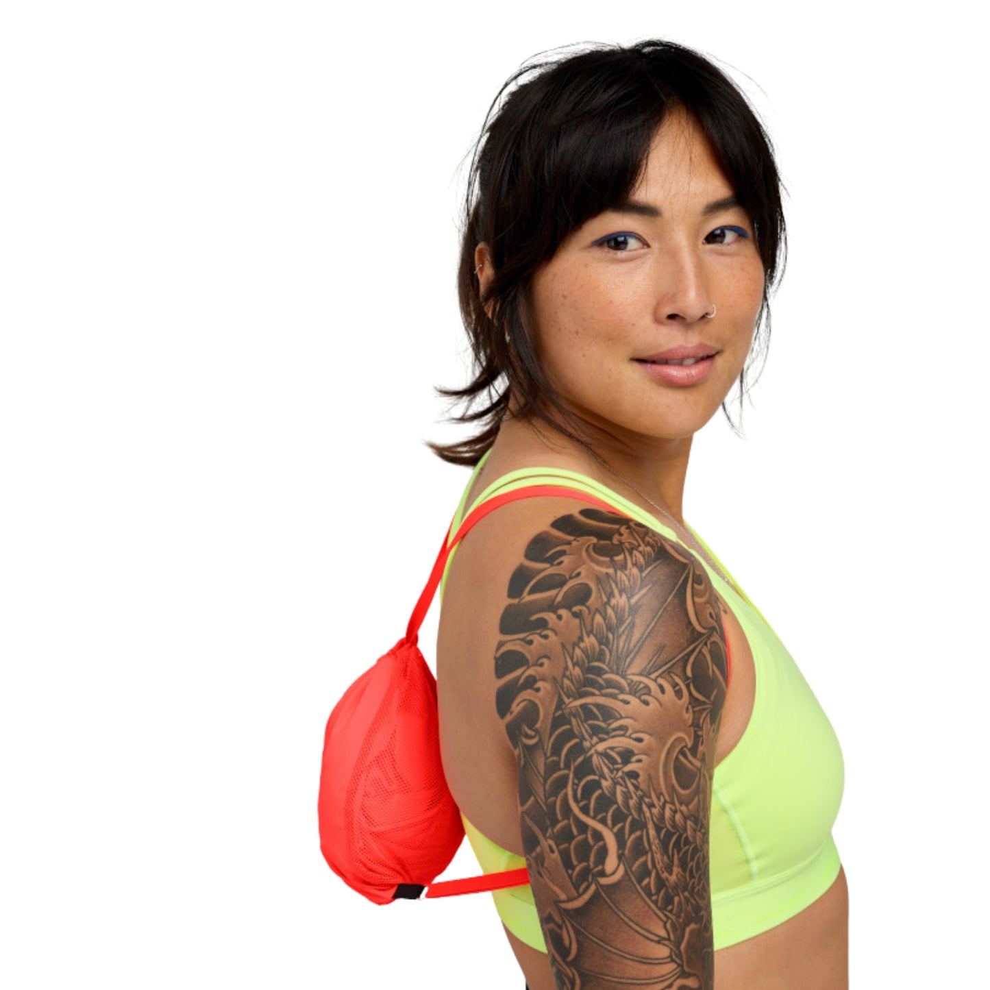 Woman wearing a small string bag on a white background
