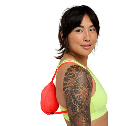 Woman wearing a small string bag on a white background