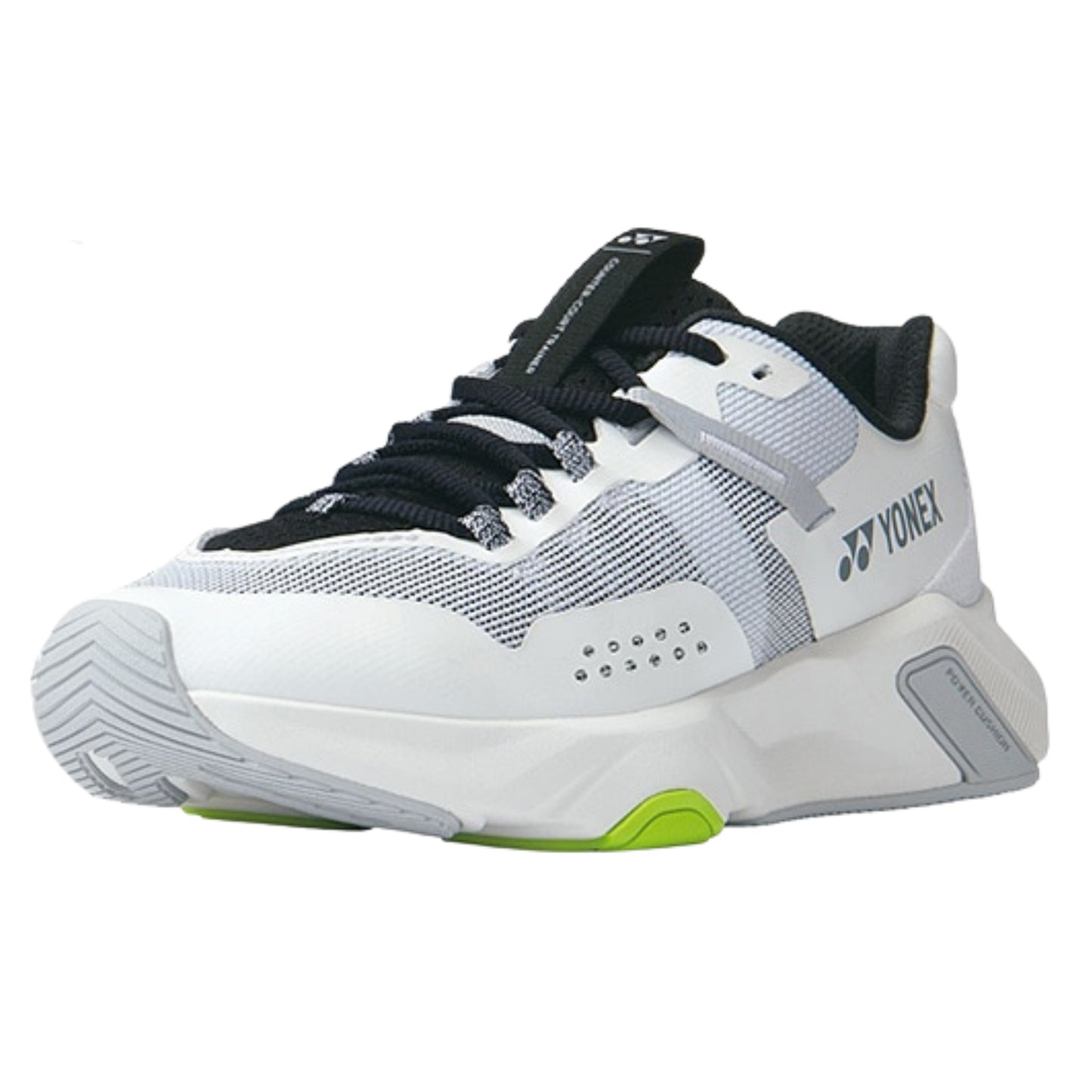 White and black Yonex running shoe with green sole on a white background