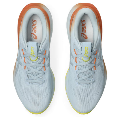 Pair of White and orange Asics running shoe with yellow accents on a white background