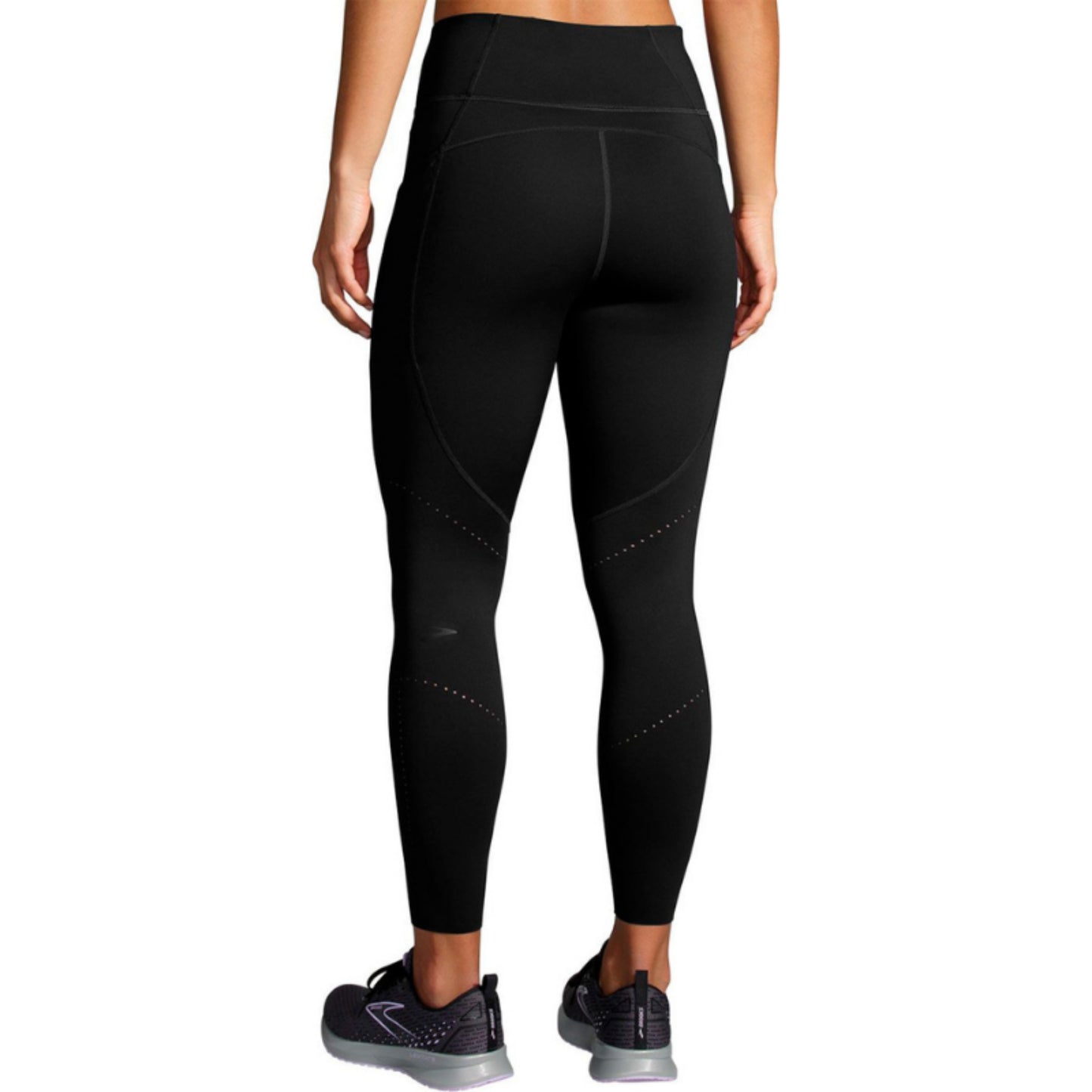 Woman wearing a black Brooks legings on a white background