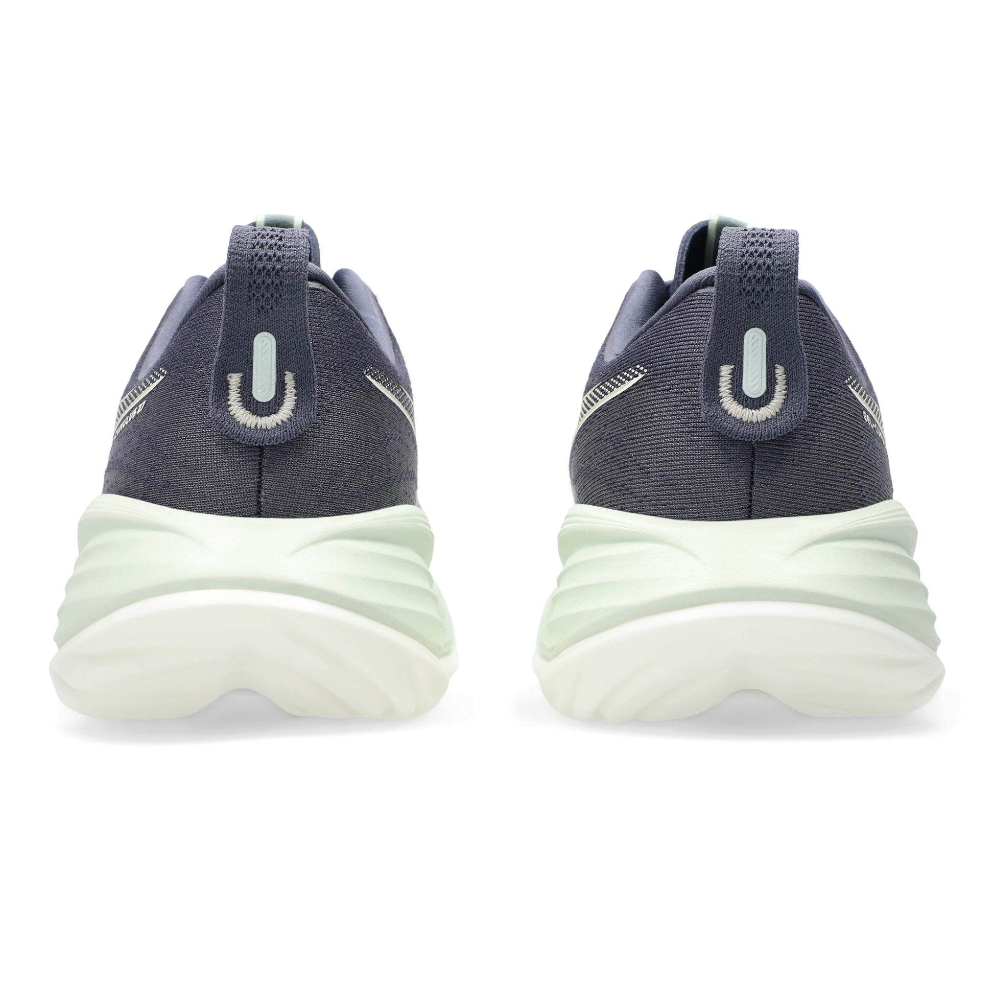 Pair of navy and white sneakers on a white background