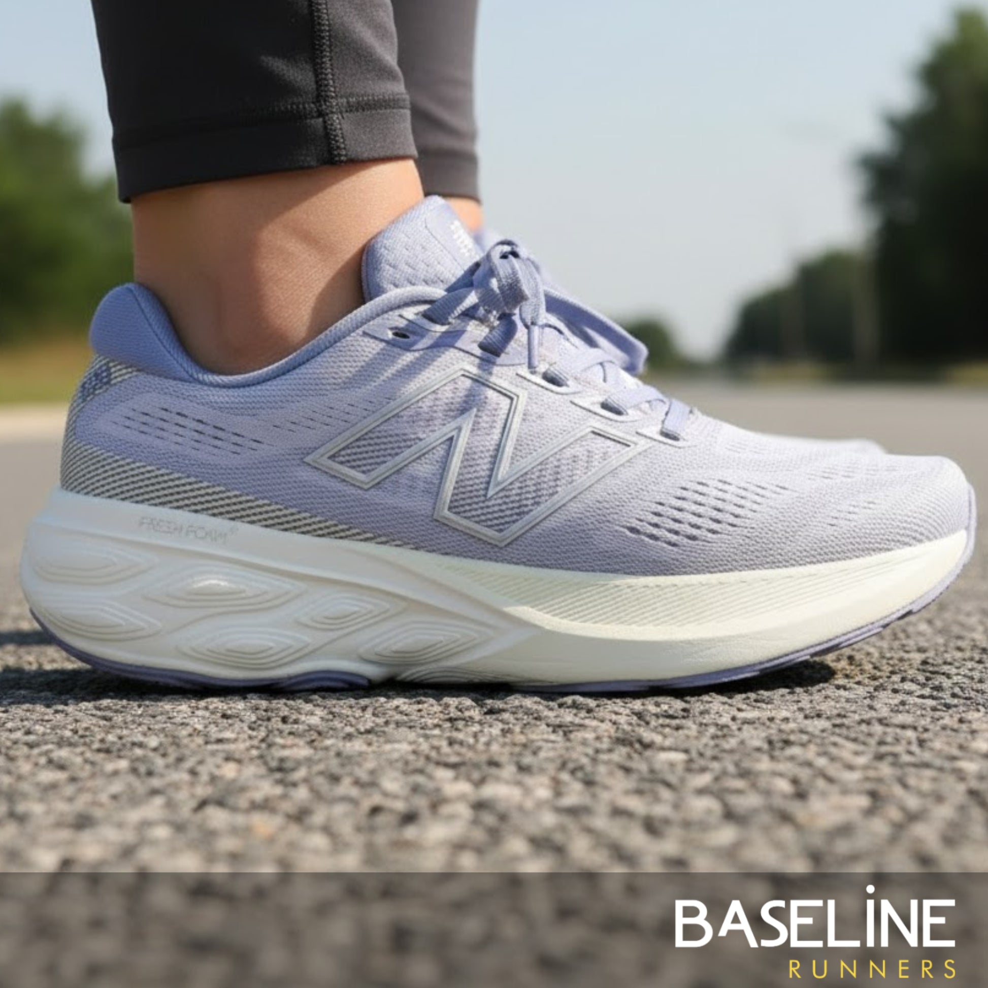 Light purple running shoe on a road with 'Baseline Runners' branding.