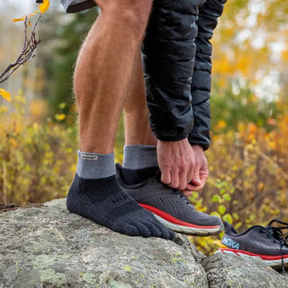 Person wearing toe-separated socks putting on a shoe