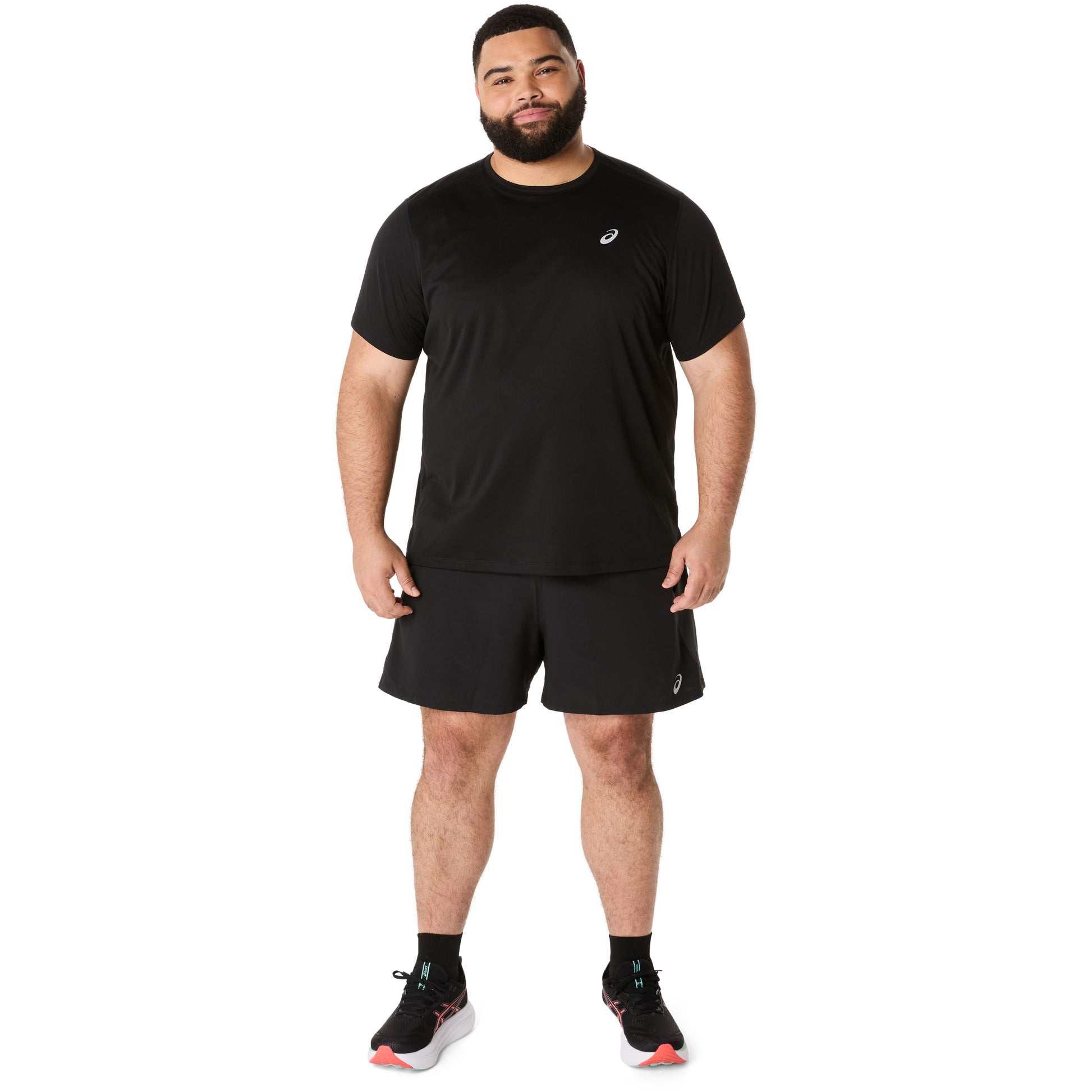 Man wearing a black athletic outfit with a logo on a white background