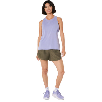 Person wearing olive green Asics shorts on a white background