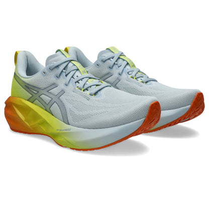 Pair of white and yellow Asics running shoes with orange accents on a white background