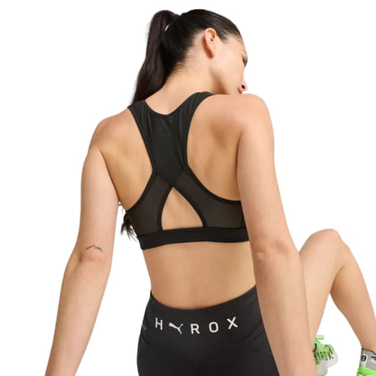 Woman wearing a black sports bra and leggings with 'Hyrox' branding on a white background