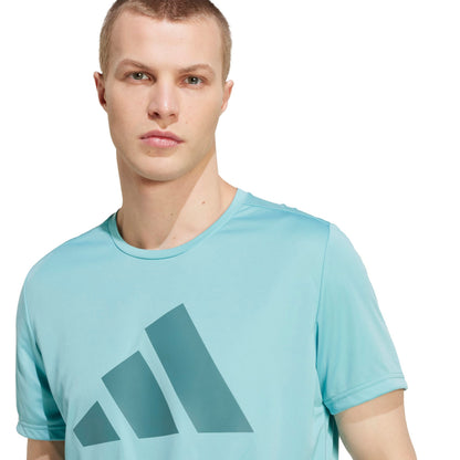 A man wearing an Adidas mint shirt