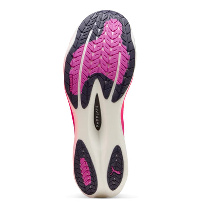 Close-up of a Puma running shoe sole with pink and black tread pattern on a white background