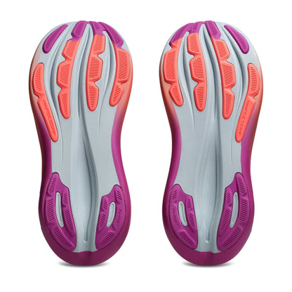 Bottom view of pink and coral thread pattern running shoe sole on a white background 