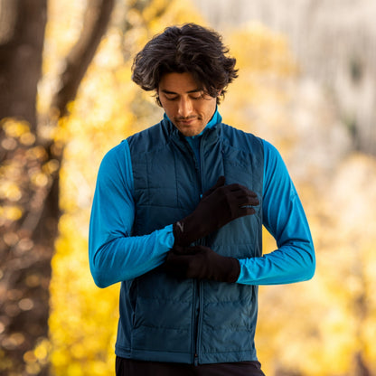Man putting on a pair of Black gloves