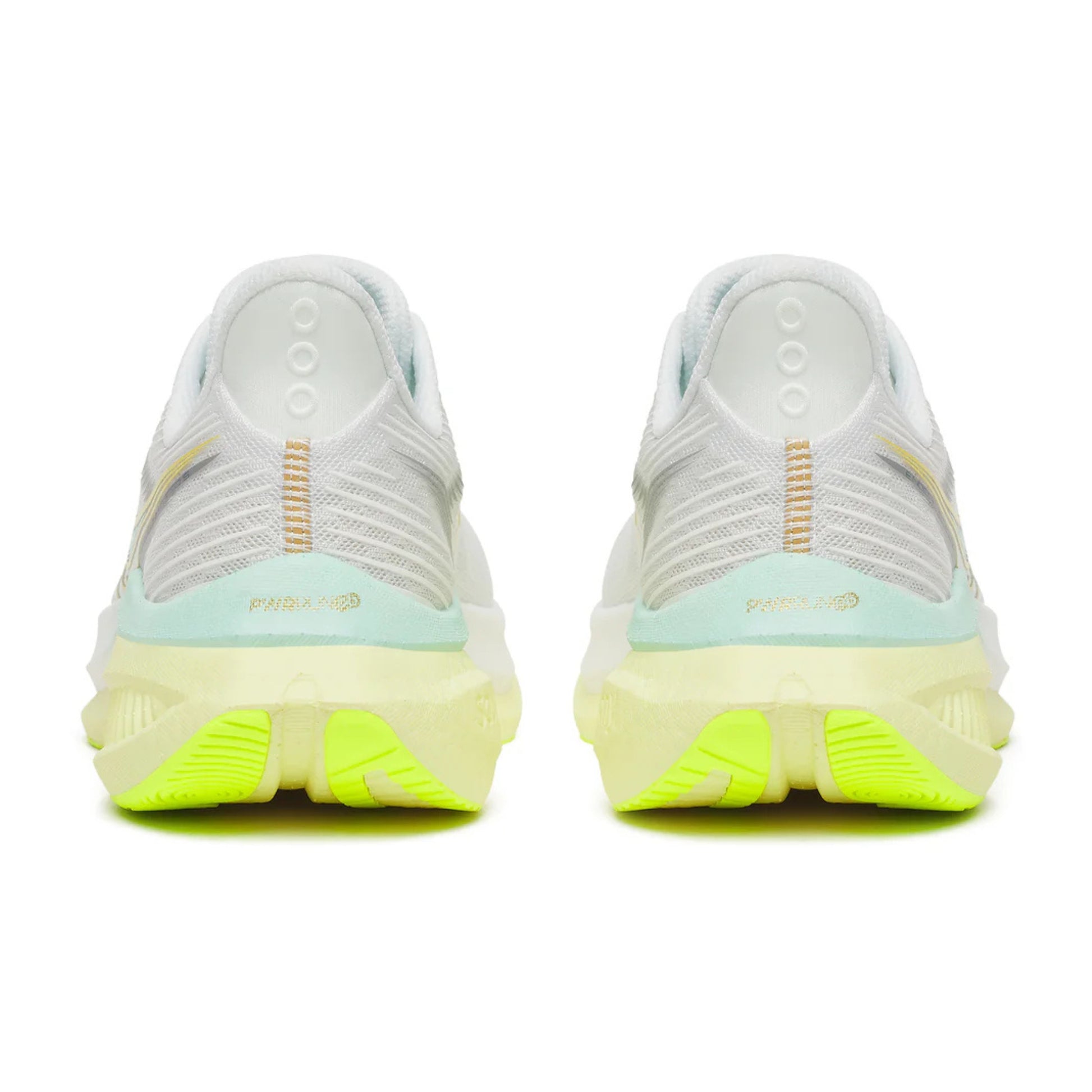 White Saucony running shoes with green sole on a white background