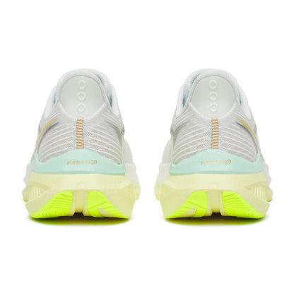 White Saucony running shoes with green sole on a white background