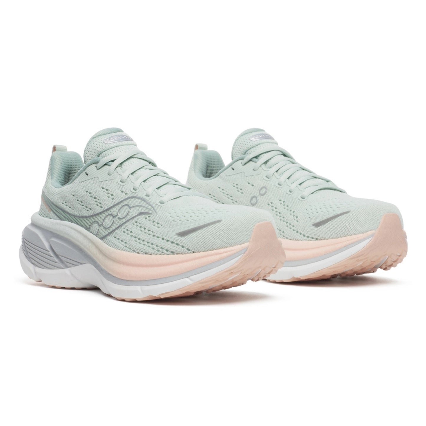 Pair of light green Saucony running shoes with pink soles on a white background