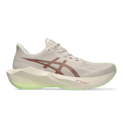 A single ASICS running shoe shown in a side profile on a clean white background. The shoe features a light beige mesh upper, a prominent dark brown ASICS stripe logo, a thick sculpted cream midsole with a glowing neon green FF Turbo sole edge.