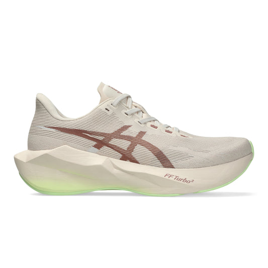 A single ASICS running shoe shown in a side profile on a clean white background. The shoe features a light beige mesh upper, a prominent dark brown ASICS stripe logo, a thick sculpted cream midsole with a glowing neon green FF Turbo sole edge.
