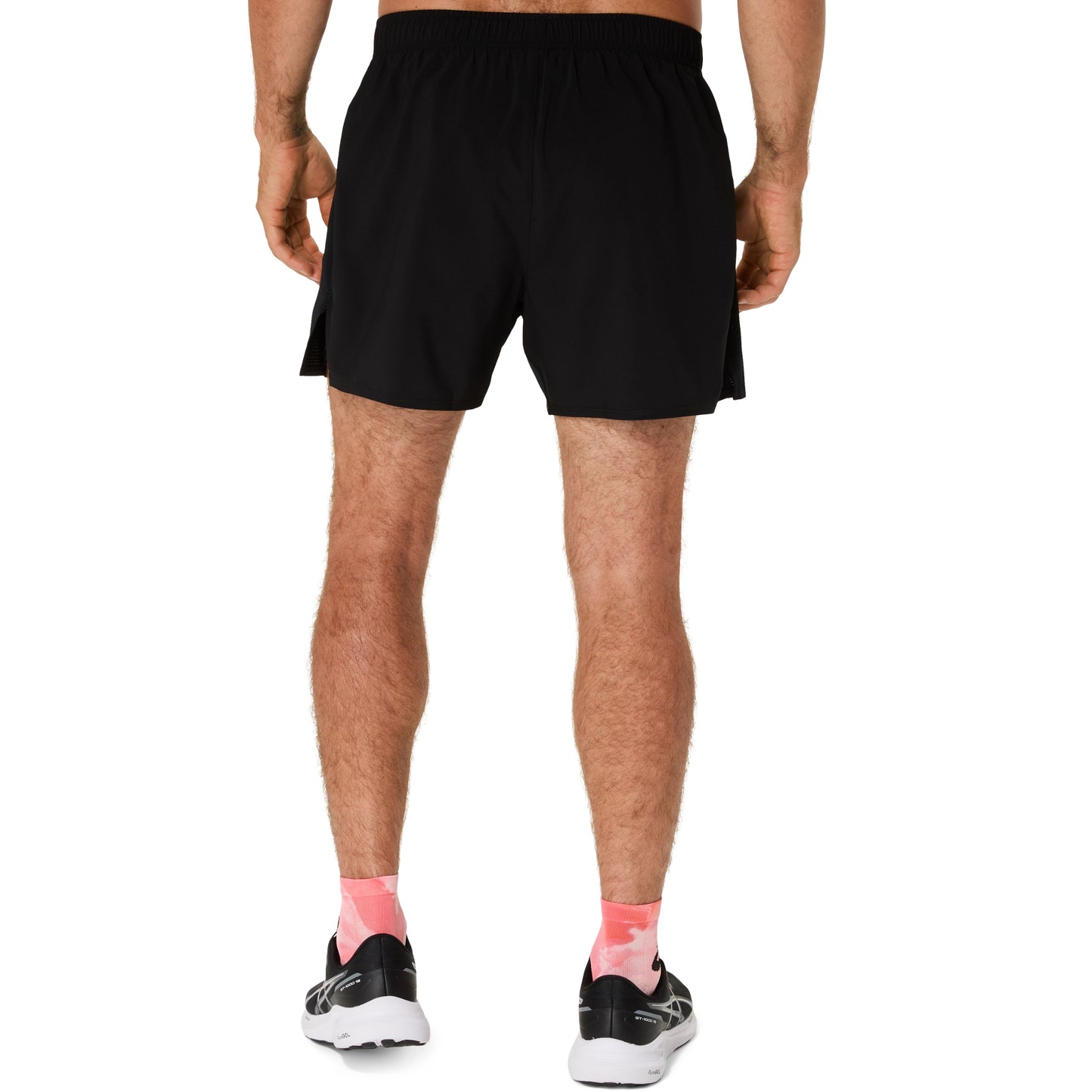 Person wearing black athletic shorts on a white background
