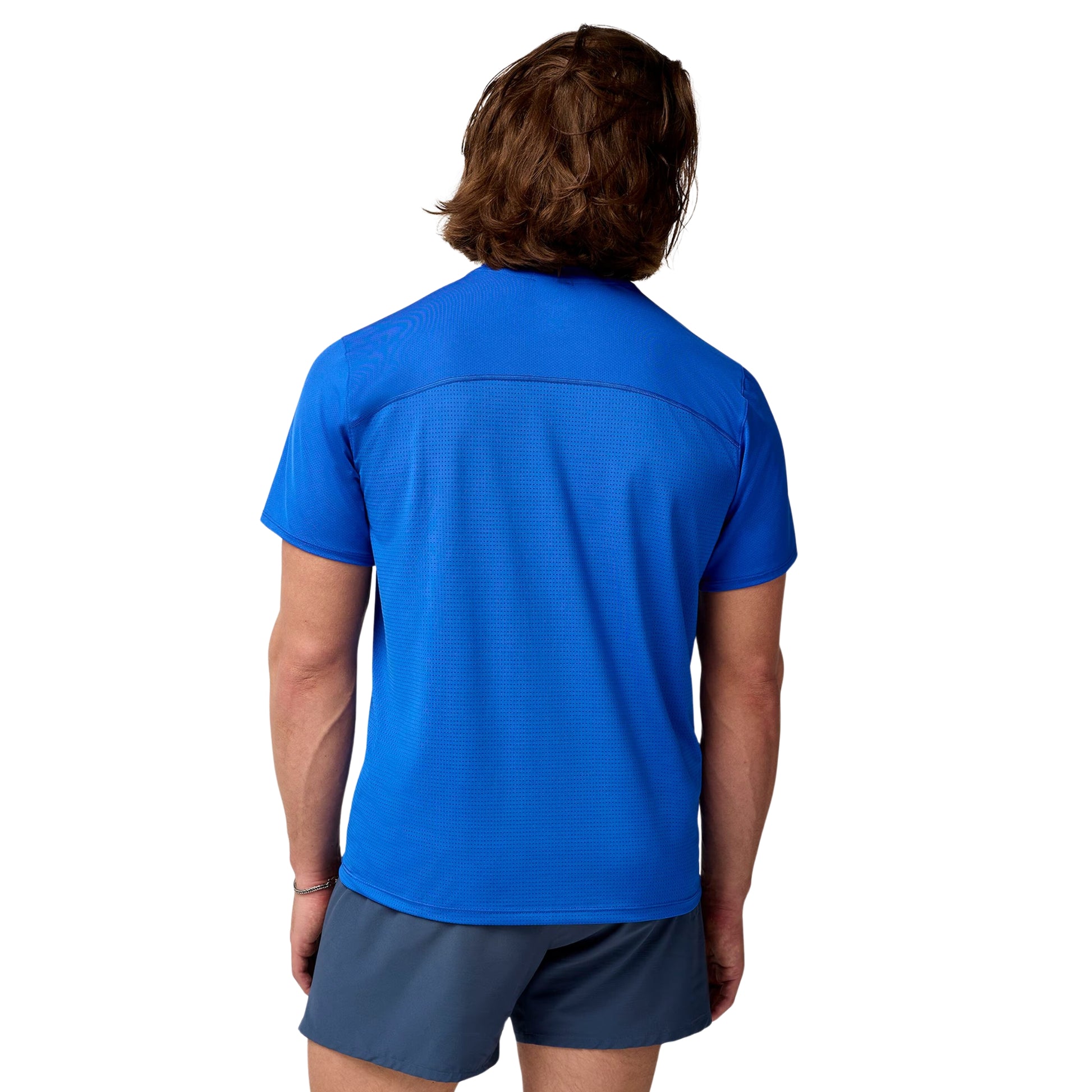 Person wearing a blue sports shirt and shorts on a white background