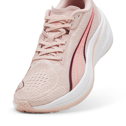 Pink Puma running shoe with white sole on a light gray background