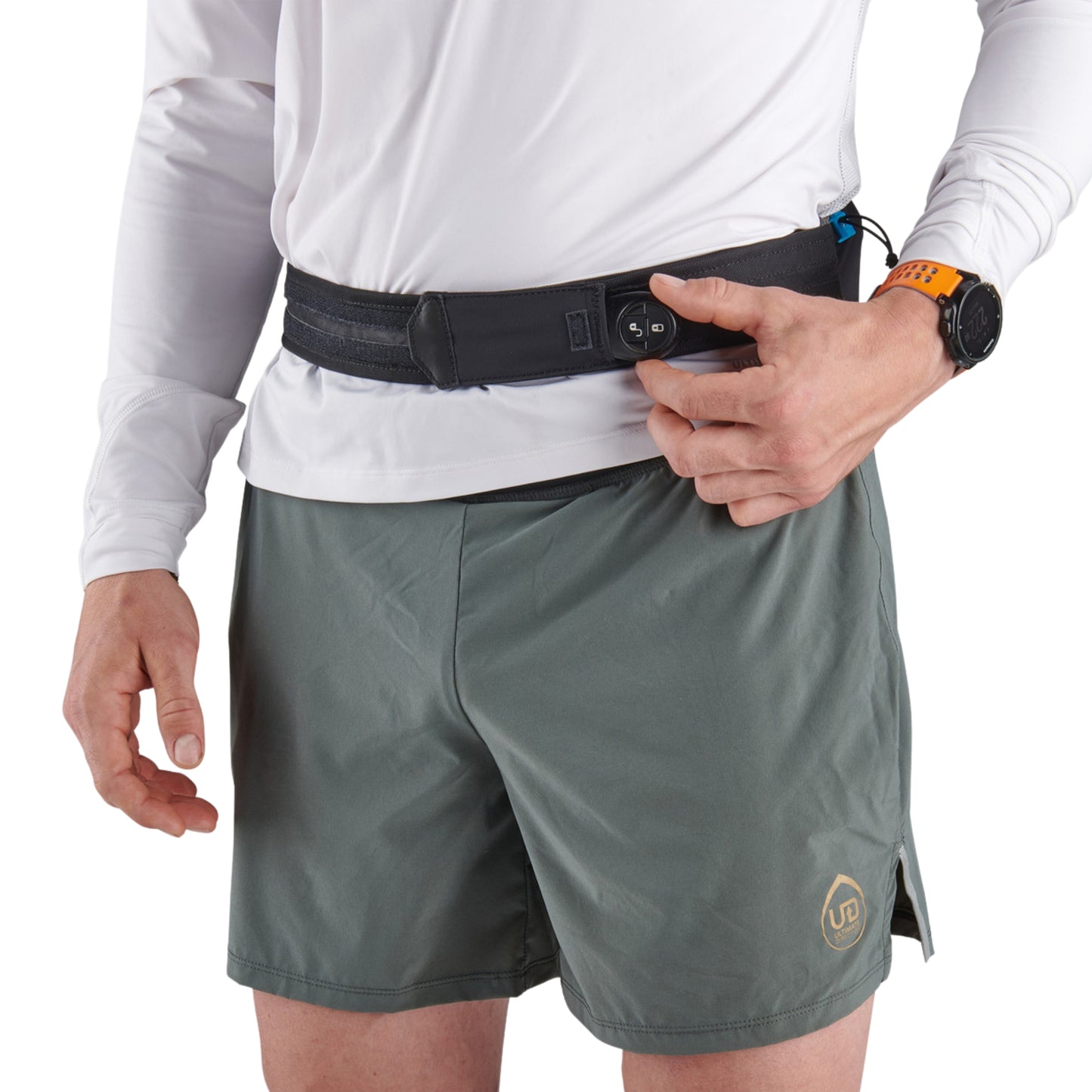 Person wearing a white long-sleeve shirt, gray shorts, and a ULTIMATE DIRECTION ULTRA BELT ONYX on a white background.
