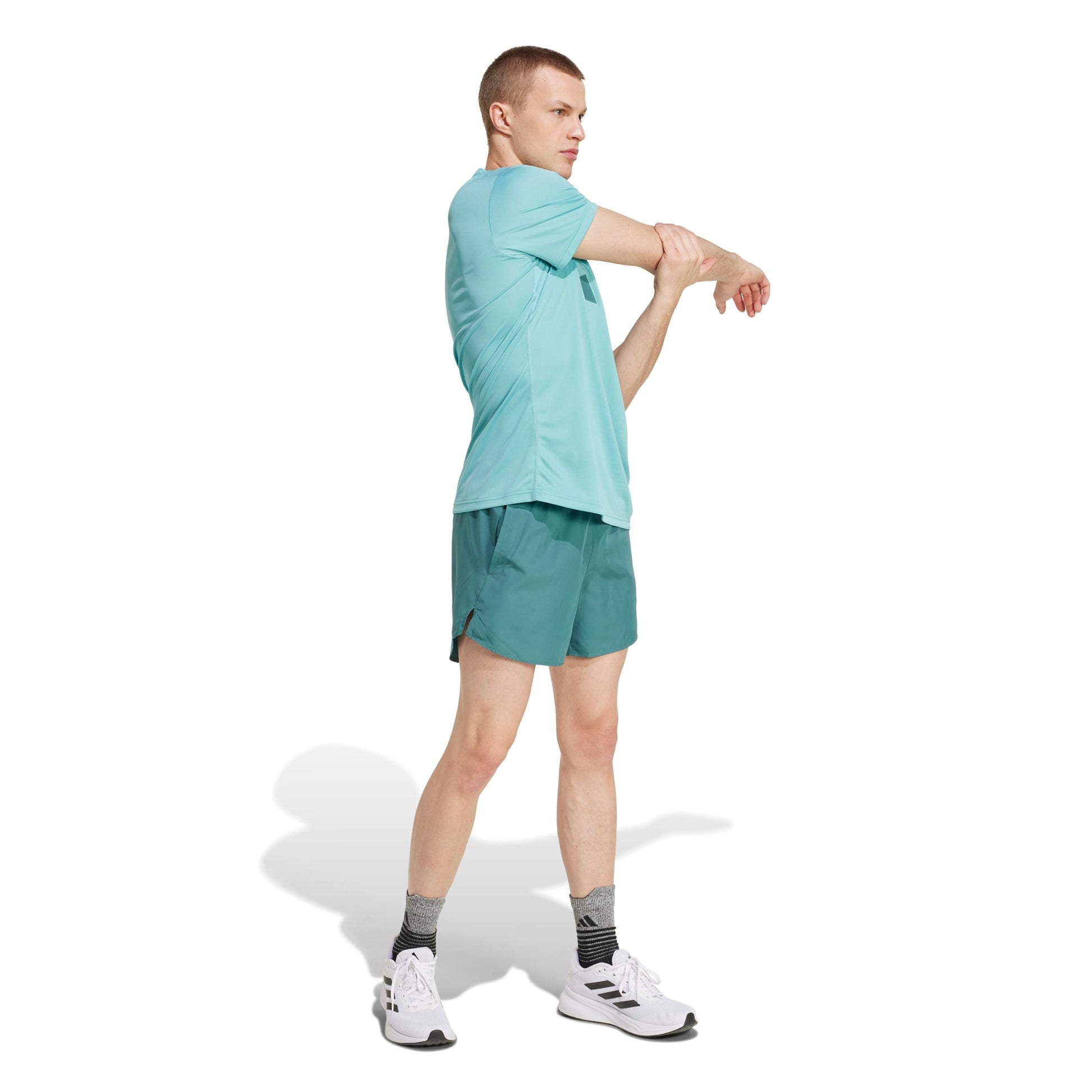 A man wearing an Adidas mint shirt