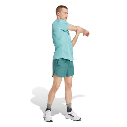 A man wearing an Adidas mint shirt