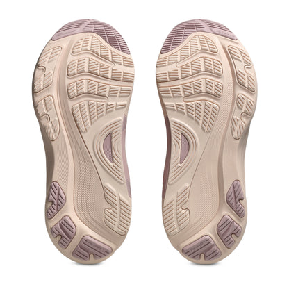 Close-up of a pair of shoes with a focus on the sole design on a white background