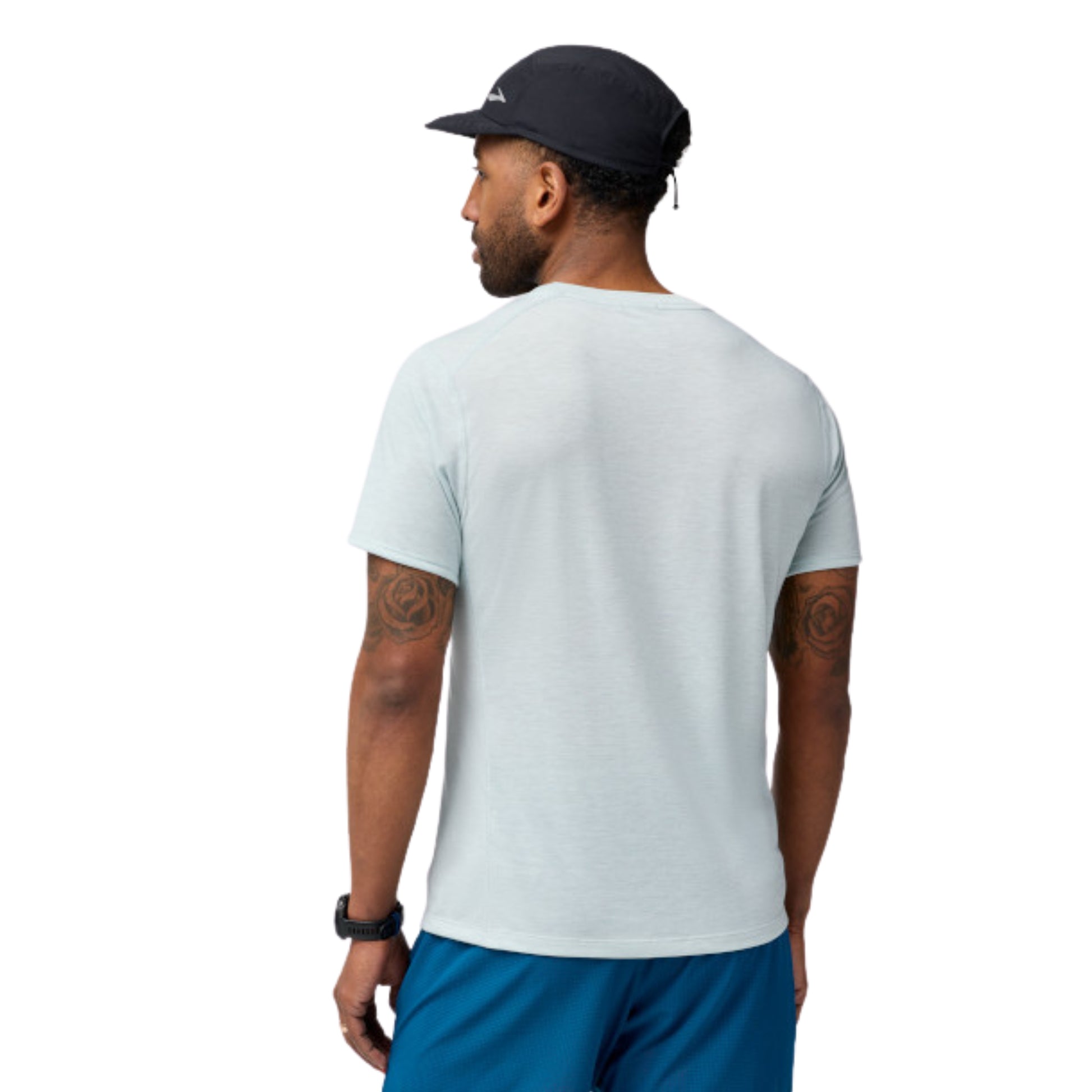 Man wearing a light gray t-shirt and blue shorts on a white background