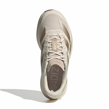 Beige running shoe with 'Adiz' branding on a white background