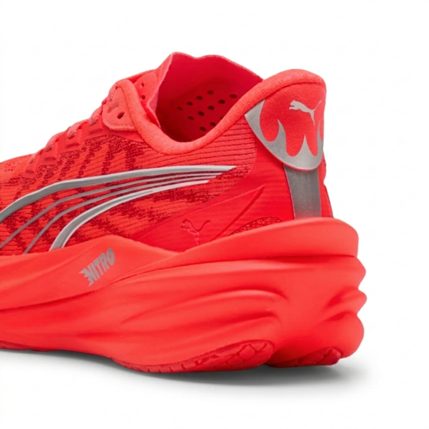 Red Puma running shoe with a prominent brand logo on a white background