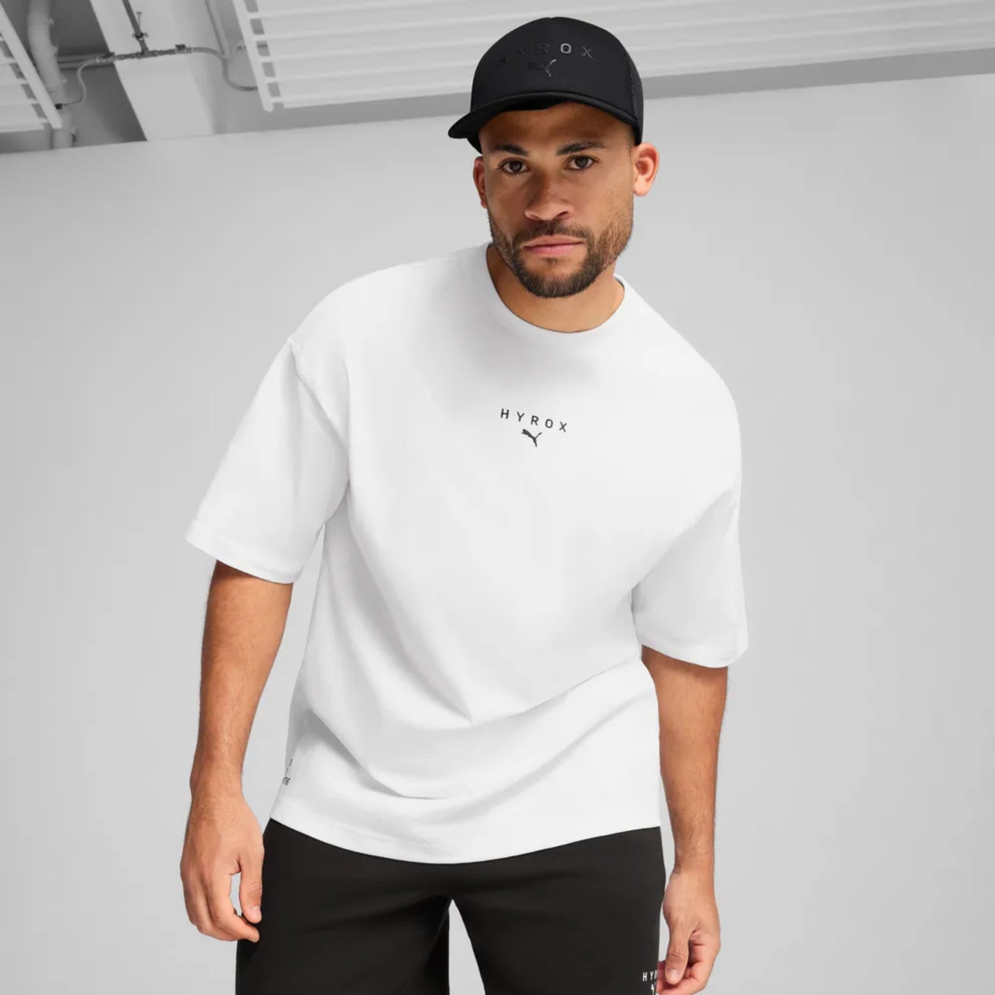 Man wearing a black Puma Hyrox cap