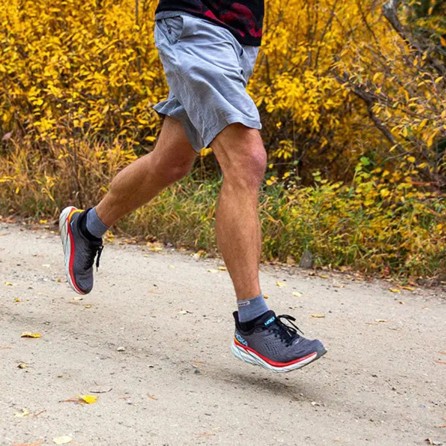 person running on a trail road