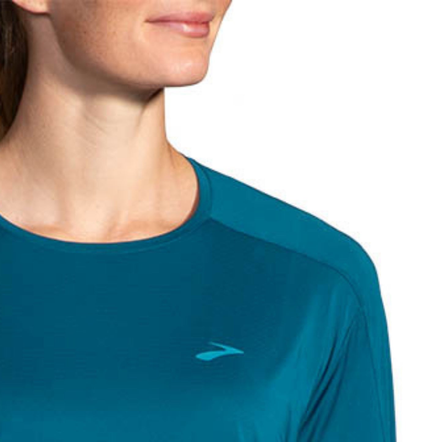 Woman wearing a blue Brooks shirt on a white background