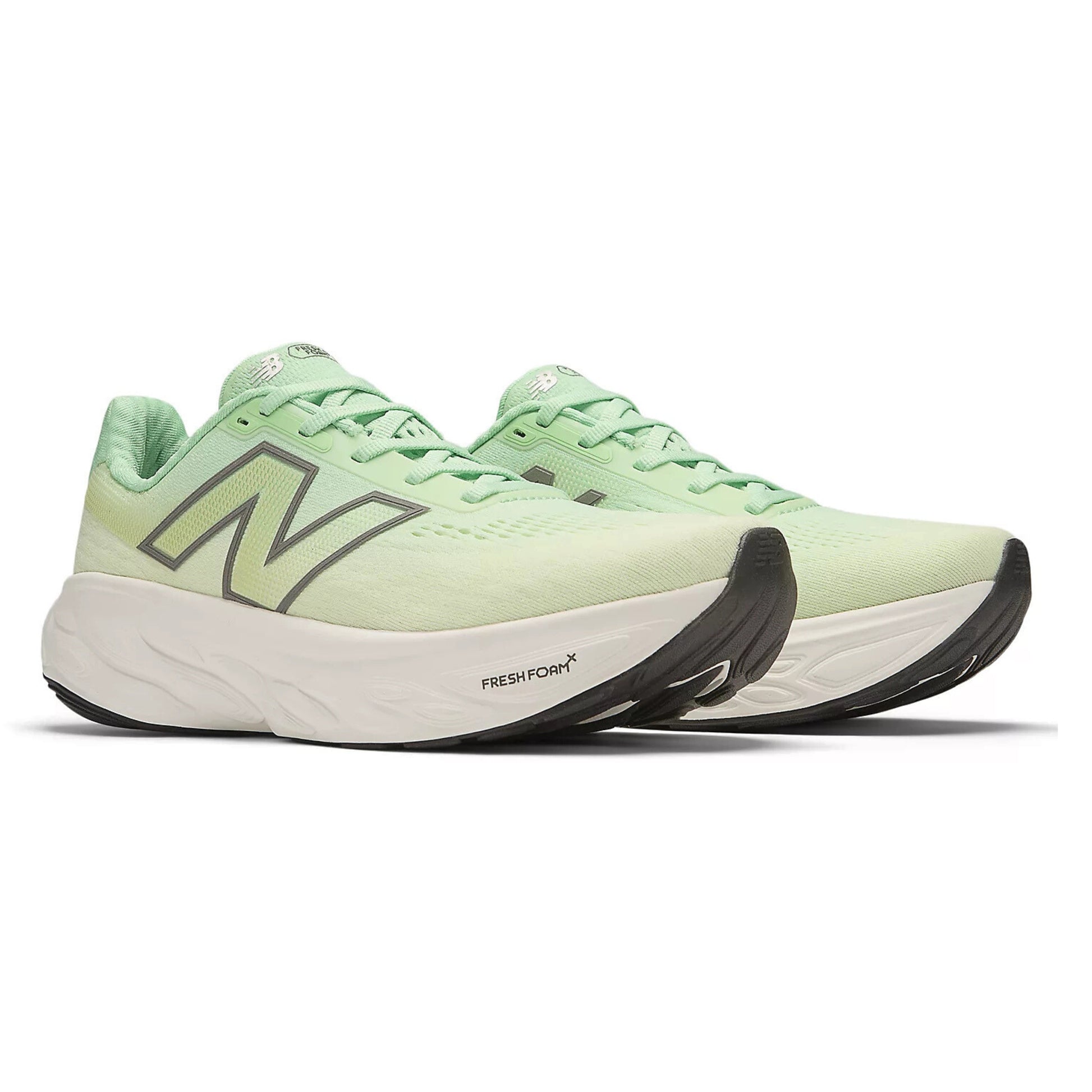 Light green running shoes with black sole on a white background