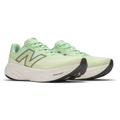 Light green running shoes with black sole on a white background
