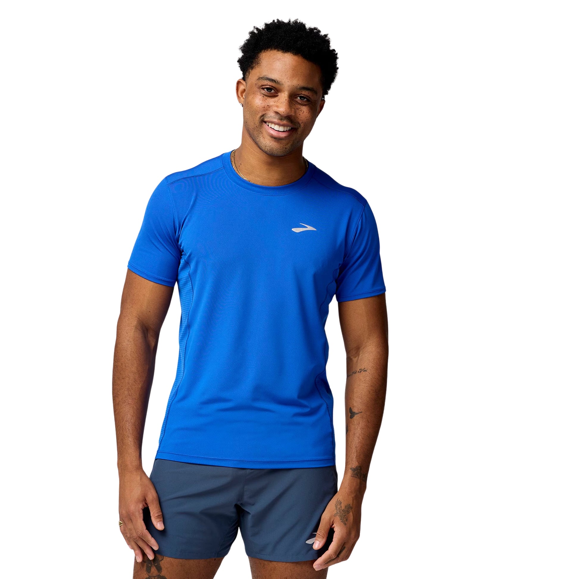 Man wearing a blue athletic shirt with a logo on a white background