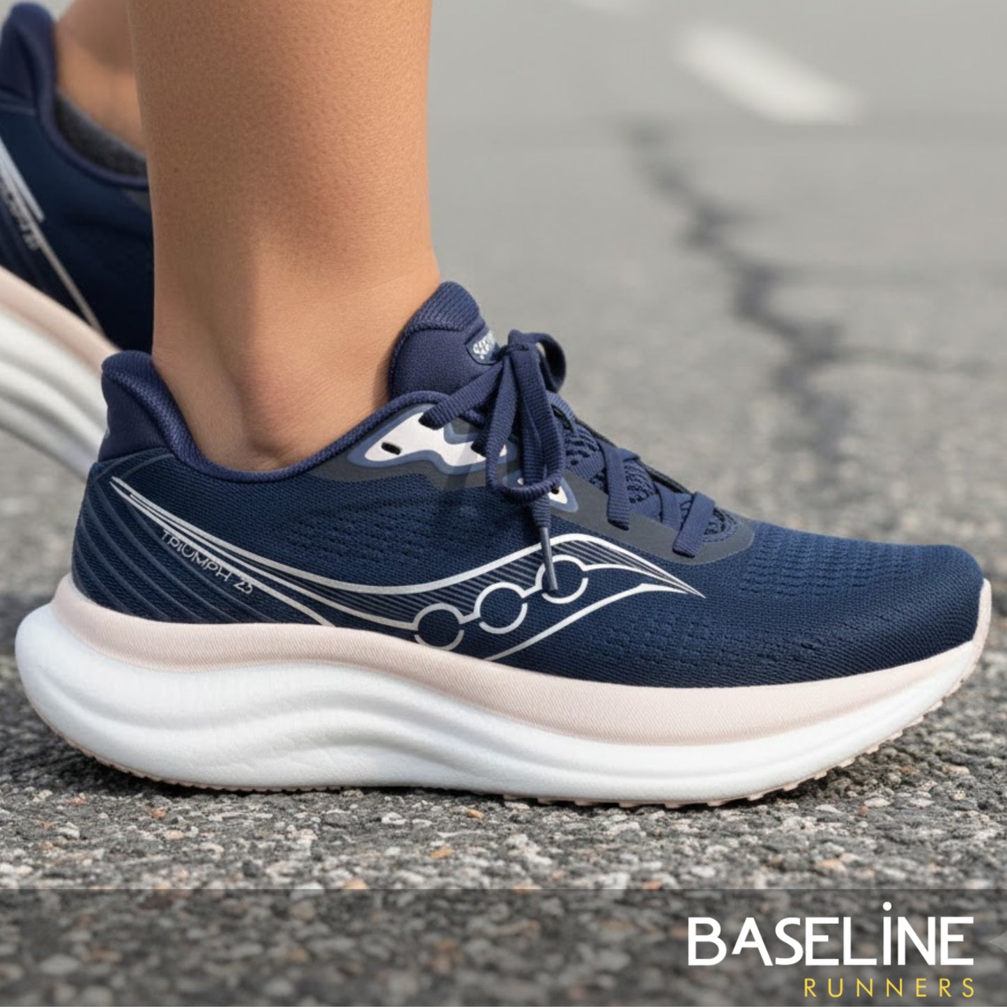 Navy running shoe with white sole on a road, featuring the 'Baseline Runners' brand.
